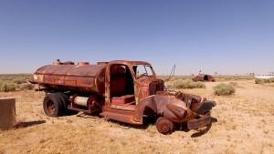 Ultimate Graveyard Film Location in the Mojave Desert- featuring desert landscape, panoramic views, apocalyptic old rusted water tanker truck, decaying cars and old vintage Packard Clipper